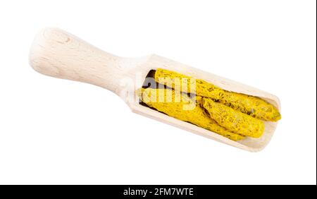 top view of dried roots of Turmeric (Curcuma Longa) in wooden scoop cutout on white background Stock Photo