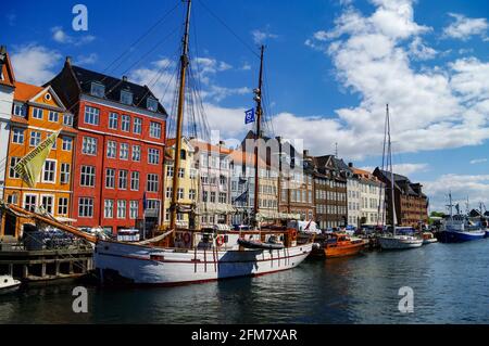 Copenhagen, Denmark - 2 may 2011: Scenic summer view of Nyhavn pier with old buildings, ships, yachts and other boats in the Old Town of Copenhagen, D Stock Photo