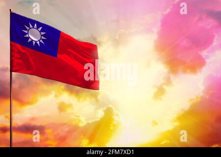 Fluttering Taiwan Province of China flag in left top corner mockup with the place for your information on beautiful colorful sunset or sunrise backgro Stock Photo