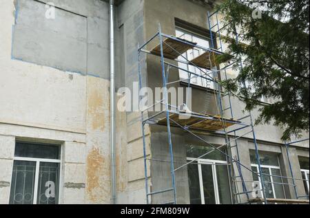 Building repair and facade renovation by plastering the facade walls and applying stucco. Plastering the facade before painting. Stock Photo