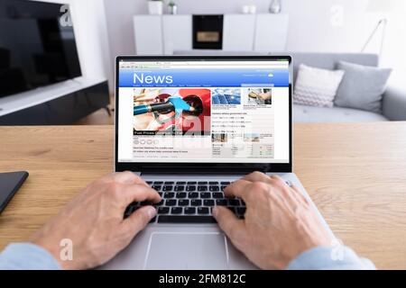 Man Reading News Website On Computer Screen Stock Photo