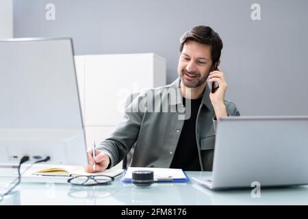 Receptionist Phone Call On Corporate Telephone At Office Stock Photo