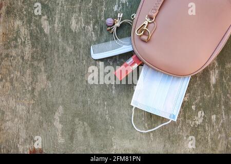 Things from open lady handbag. Concept of protect yourself from COVID-2019. Top view. Stock Photo