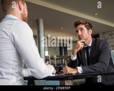 Handsome two businessmen have a meeting in cafe Stock Photo
