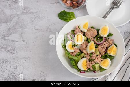 Cucumber, canned tuna and avocado salad with egg, top view Stock Photo