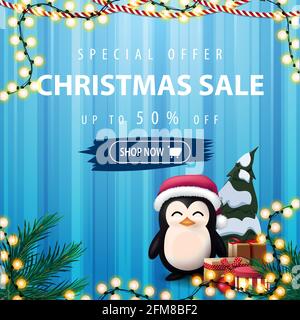 Special offer, Christmas sale, up to 50 off, square blue discount banner with curtain on the background, garlands and penguin in Santa Claus hat with Stock Photo