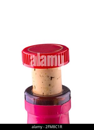 the neck of a wine bottle with a stopper and a red cap Stock Photo