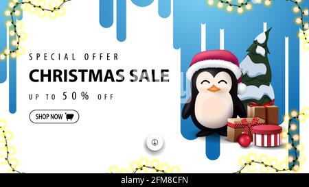 Special offer, Christmas sale, up to 50 off, white discount banner with blue streaks of paint on the white wall and penguin in Santa Claus hat with pr Stock Photo