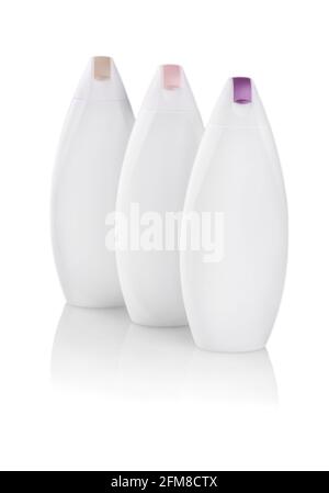 White plastic bottles with colored capes of body care and beauty products. Studio photography of plastic bottle for shampoo - isolated on white backgr Stock Photo