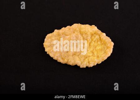 a piece of corn flakes on black background Stock Photo
