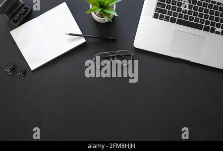 Office black workspace with office supplies on black background, flat lay, copy space Stock Photo