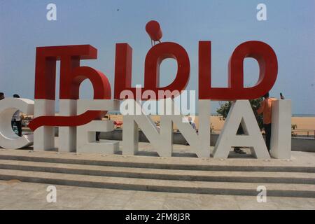 Visitors to Chennai Marina beach  enjoy the cool evening sea breeze talking selfie photograph at Namma Chennai landmark Stock Photo