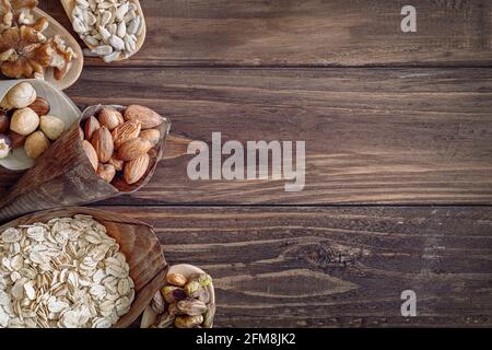 Variety of grains and mixed nuts on wooden background , top view with copy space Stock Photo