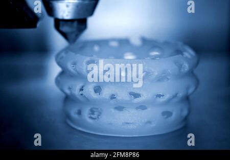 3d printer printing objects blue gray color form closeup. Stock Photo