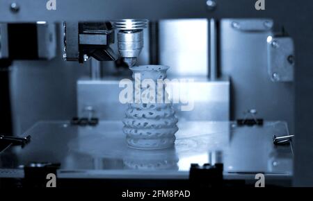 3D printer prints from the plastic figure closeup. Stock Photo