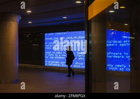 Female walking in a tunnel with binary code walls Stock Photo