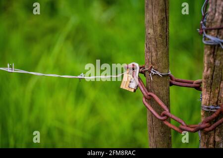Padlock with a three digit combination on a fence. Stock Photo