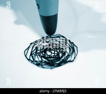 Man 3d pen draws a circle on white paper Stock Photo