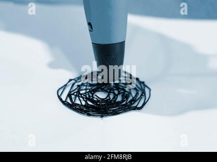 Man 3d pen draws a circle on white paper Stock Photo
