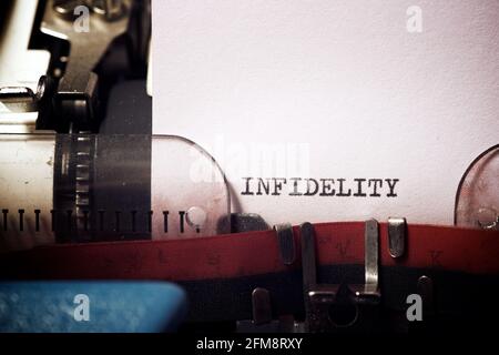 Infidelity word written with a typewriter. Stock Photo