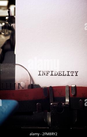 Infidelity word written with a typewriter. Stock Photo