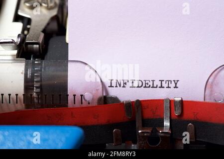 Infidelity word written with a typewriter. Stock Photo