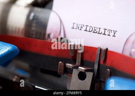 Infidelity word written with a typewriter. Stock Photo