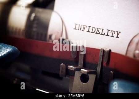 Infidelity word written with a typewriter. Stock Photo