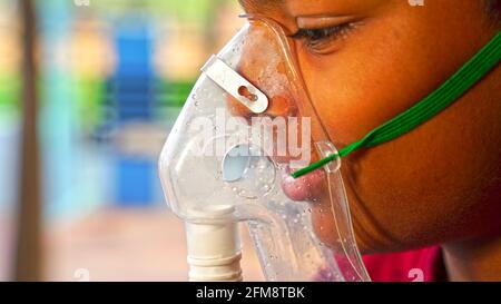 30 April 2021- Reengus, Sikar, India. Oxygen pipe in nose, Nasal cannula or Oxygen mask Nasal Cannula for Oxygen Therapy holding on patient face. Covi Stock Photo