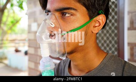 30 April 2021- Reengus, Sikar, India. Oxygen pipe in nose, Nasal cannula or Oxygen mask Nasal Cannula for Oxygen Therapy holding on patient face. Covi Stock Photo