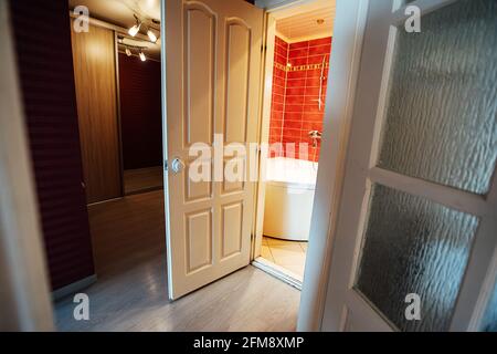 a room in a cheap hotel. minimalistic interior of an economy class hotel room. overnight stay for the traveler. several beds and a table Stock Photo