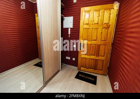 a room in a cheap hotel. minimalistic interior of an economy class hotel room. overnight stay for the traveler. several beds and a table Stock Photo