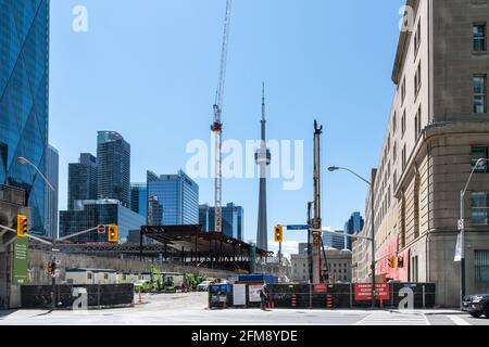 Construction site by the Saint Lawrence Hall (right). Urban sprawl due to high demand for real estate. The city skyline with the CN Tower is seen in the Stock Photo