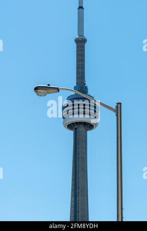 CN Tower or Canadian National Tower framed in an electric lamp in the downtown district of Toronto, Canada