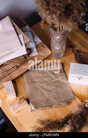 Dry reeds, reeds in retro vase, wood and neutral colors. Mockup craft paper. Stock Photo