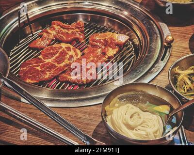 Bulgogi is marinated slices of beef grilled on a barbecue Stock Photo