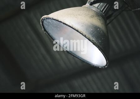 Old electric lamp on gray background Stock Photo