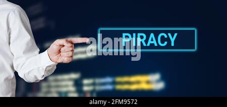 Male hand points to the word piracy. Internet technology cyberspace piracy crime concept. Stock Photo