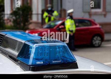 Freiburg, Germany. 05th May, 2021. Two police officers wearing mouth-nose protection check a car. Credit: Philipp von Ditfurth/dpa/Alamy Live News Stock Photo