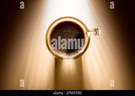 coffee cup with black coffee, top view on background with sunlight. Stock Photo