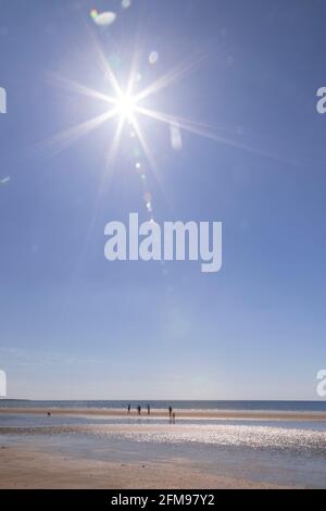 Sunstar over Harlech beach, Gwynedd, Wales Stock Photo