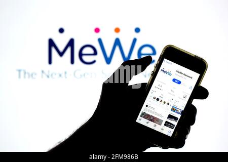 In this photo illustration a MeWe app seen displayed on a smartphone with  the MeWe logo in the background. (Photo by Thiago Prudencio / SOPA  Images/Sipa USA Stock Photo - Alamy