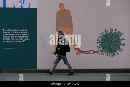 A man walks past part of the 'IN THESE STRANGE TIMES: an evolving series created in response to the pandemic' exhibition at the Science Gallery in Dublin's city centre. There have been four further deaths linked to Covid-19 and an additional 434 confirmed cases, the Department of Health has said. Dr. Holohan has called for caution as the country continues to open up. Picture date: Friday May 7, 2021. See PA story IRISH Coronavirus. Stock Photo