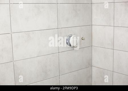bathroom gray tiles with neat rectangular patterns and built-in shower. Bathroom Tiles Texture. repair. Stock Photo