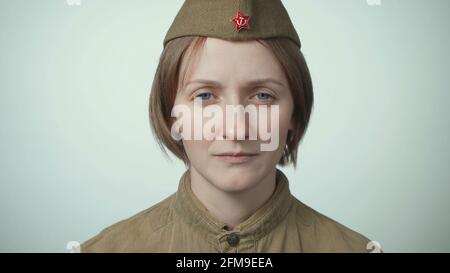 Photo of young woman wearing soviet red army uniform on white Stock Photo