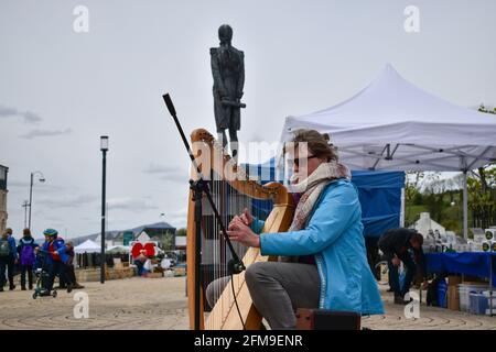 Bantry, West Cork, Ireland. 7th May, Streets of Bantry we're busy today as it is first market of the month, musician playing harp at Bantry market. Credit: Karlis Dzjamko/Alamy Live News Stock Photo