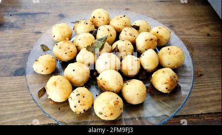 Suji appe or rice appe or appam, an Indian snack with onion, peanuts and tamarind dip in india Stock Photo