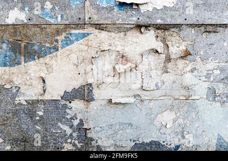 Poster wall texture, grungy background with peeled off dirty papers Stock Photo