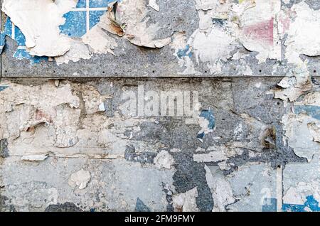 Poster wall texture, grungy background with peeled off dirty papers Stock Photo