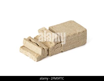 Sliced halva isolated on a white background. Traditional oriental dessert. Vegan food. Stock Photo